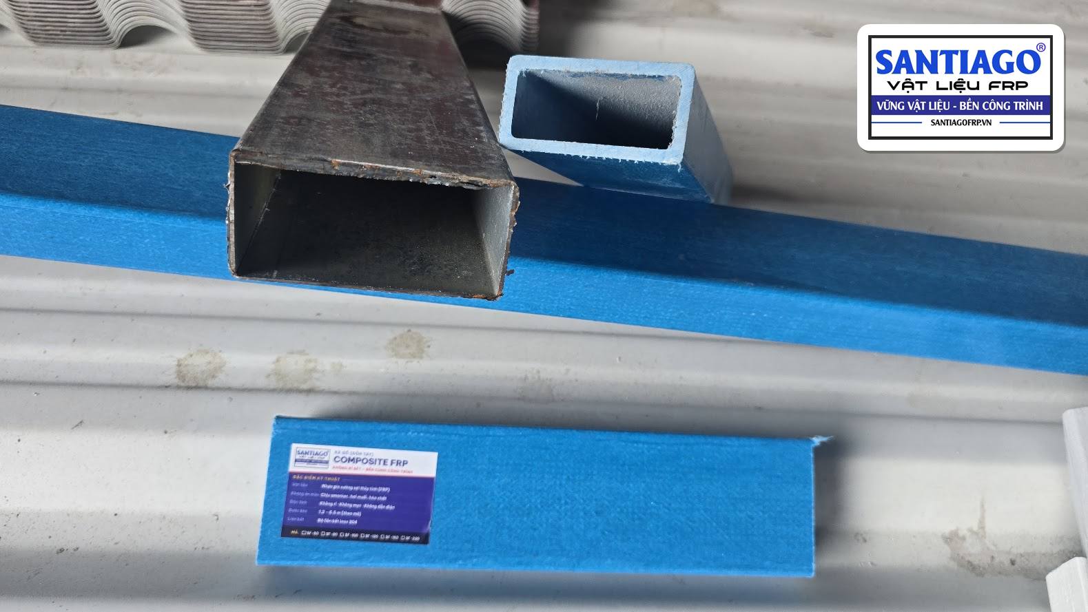 Hộp thép rỉ sét đặt cạnh thanh xà gồ composite xanh